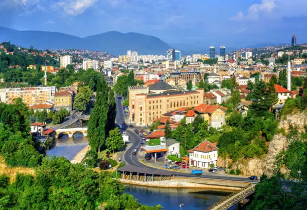 Aerial view of Sarajevo, the capital of Bosnia and Herzegovina, with Latin Bridge, Miljacka River, National Library and the modern city