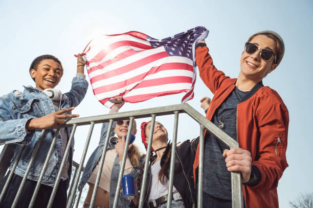 istock teenagers waving american flag 684001106
