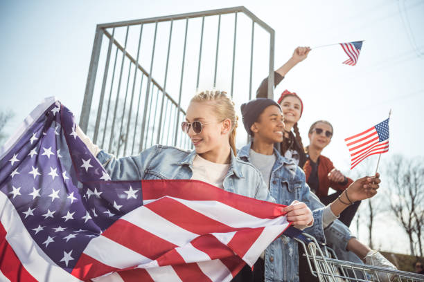 istock teenagers having fun and waving american flags 684001622