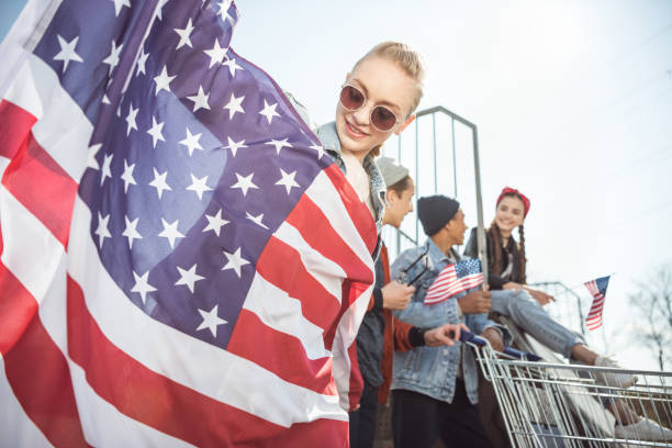 istock teenagers having fun and waving american flags 684004812