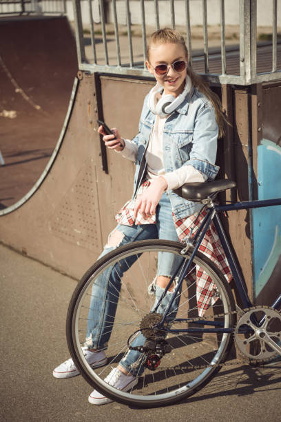 istock girl with bmx bike using smartphone 684020156