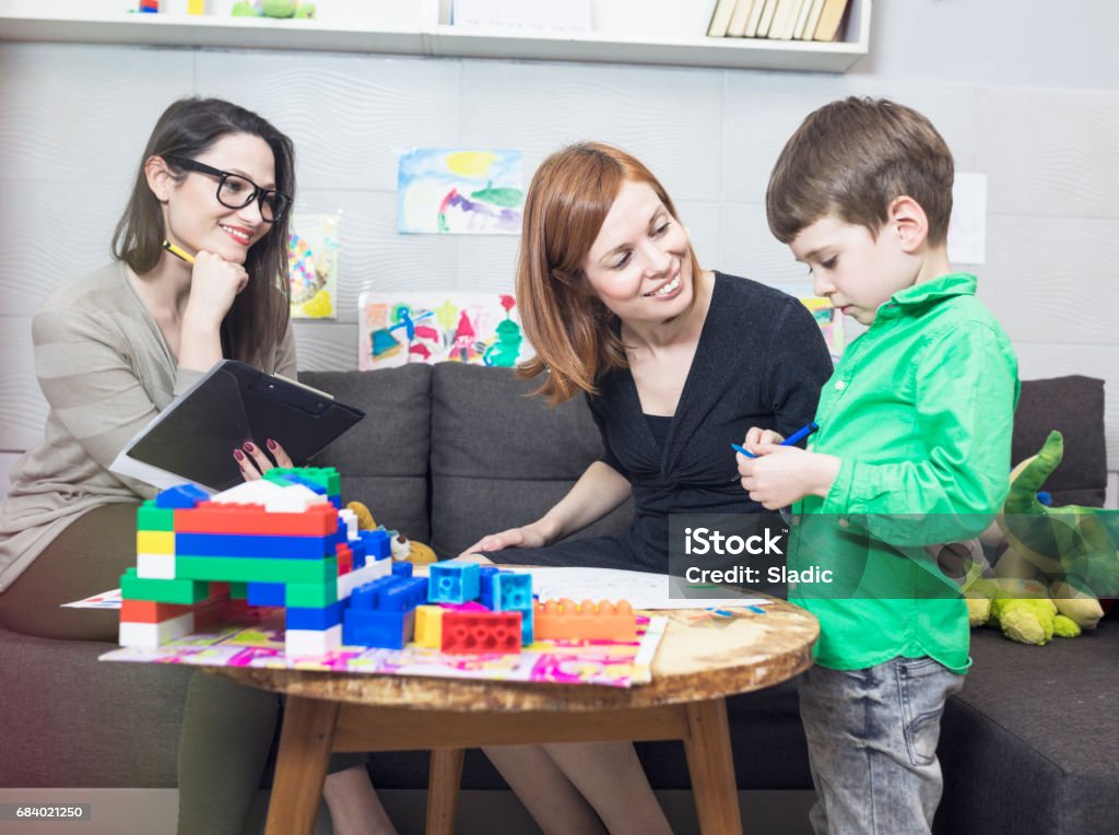 Child psychologist at work School counsellor, pupil and parent discussion Child Stock Photo