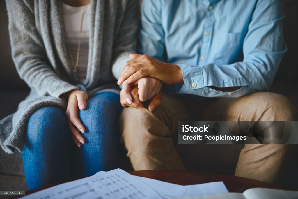 Let love be your greatest source of support Closeup shot of a couple holding hands in comfort Grief Stock Photo