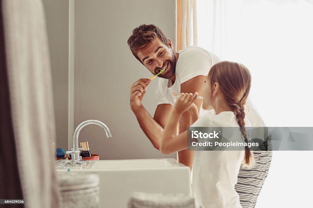 No cavities for this family Shot of a happy father and his little girl washing their hands together in the bathroom Brushing Teeth Stock Photo