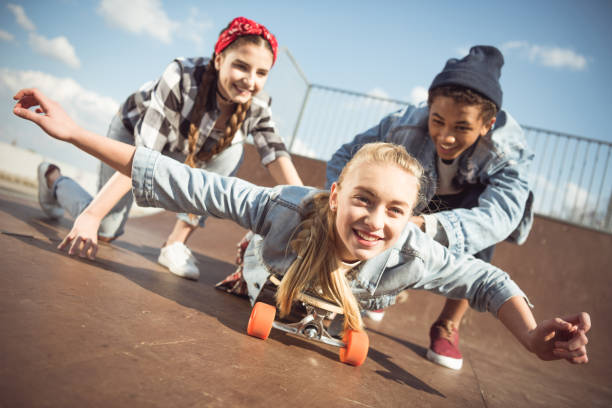 istock friends helping girl riding skateboard 684031498