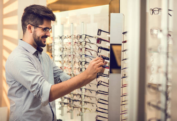 istock Happy man choosing the most suitable eyeglasses in a store. 684032238