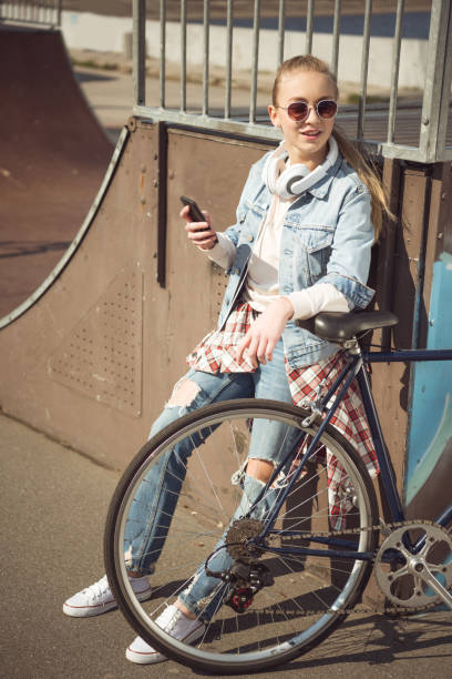 istock girl with bmx bike using smartphone 684032824