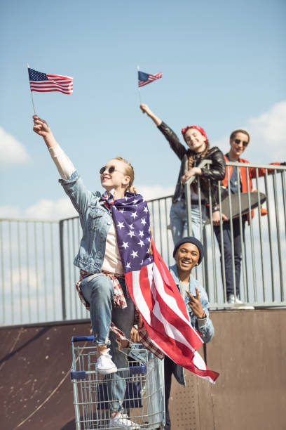 istock Teenagers waving american flags 684043334
