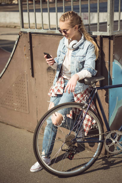 istock girl with bmx bike using smartphone 684056924
