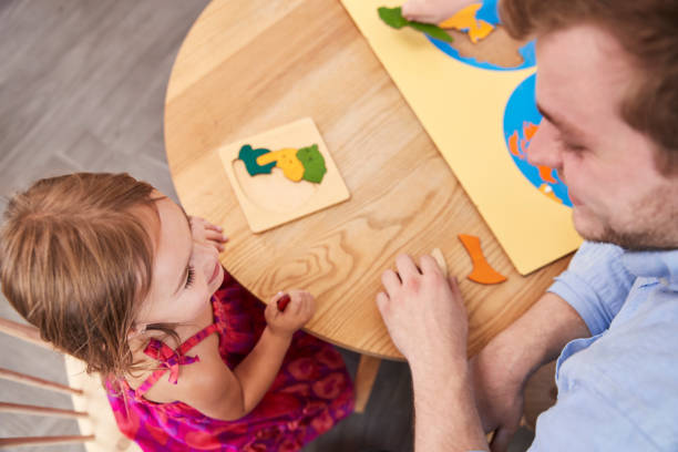Teacher And Pupil Using Wooden Shapes In Montessori School Teacher And Pupil Using Wooden Shapes In Montessori School teacher classroom child education stock pictures, royalty-free photos & images