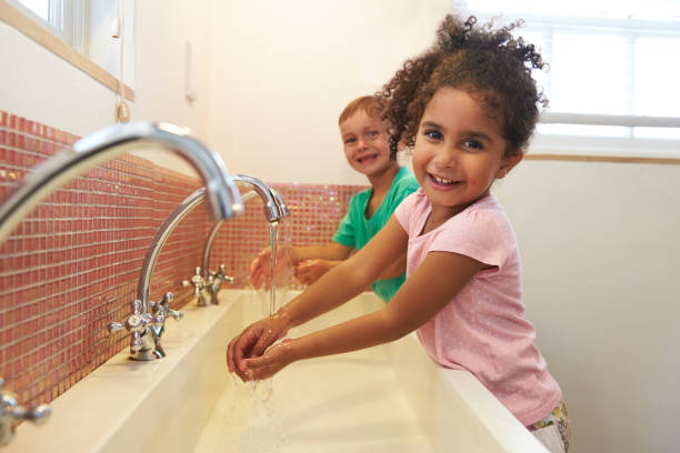 Pupils At Montessori School Washing Hands In Washroom Pupils At Montessori School Washing Hands In Washroom montessori stock pictures, royalty-free photos & images