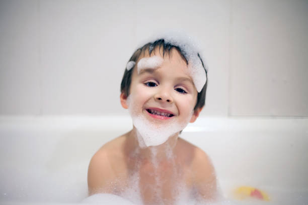 istock Cute boy in bathtub evening time, smiling, covered with soap foam 684063014