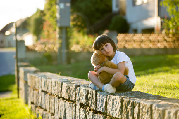 istock Sweet boy, playing with teddy bear on a small rural path on sunset, summertime 684063184