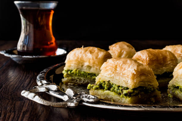 istock Turkish Dessert Baklava with tea on silver tray. 684078838