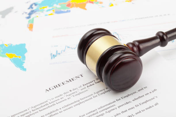 istock Wooden judge's gavel and calculator over some financial documents 684078900