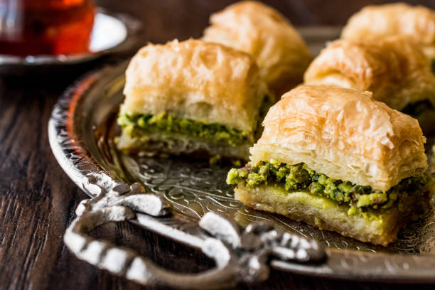 istock Turkish Dessert Baklava with tea on silver tray. 684078956