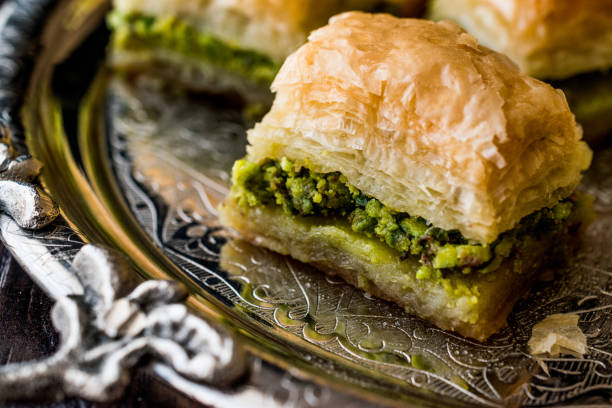 istock Turkish Dessert Baklava with pistachio on silver tray. 684082214
