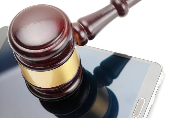 istock Smartphone under judge gavel - 1 to 1 ratio 684082264
