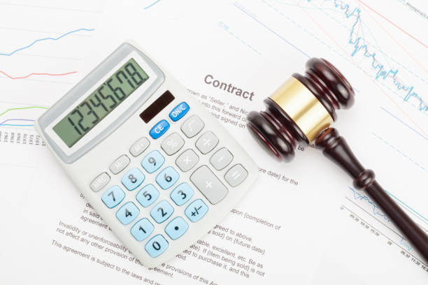 istock Wooden judge's gavel and calculator over some financial documents 684082920