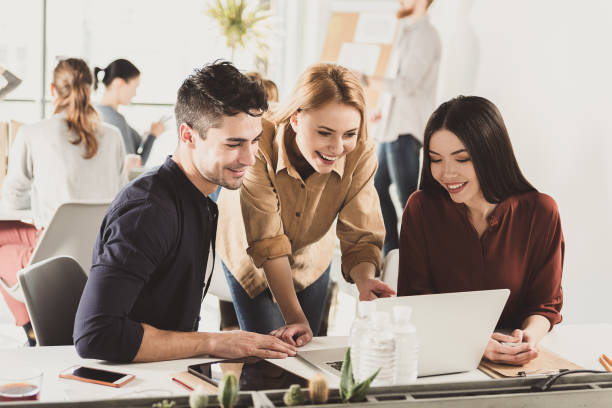 istock Hilarious colleagues glancing on laptop 684083176