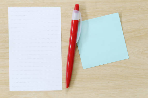 istock Note paper and red pen placed on wooden floor. 684086416