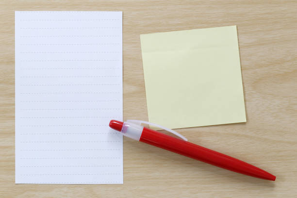 istock Note paper and red pen placed on wooden floor. 684086450