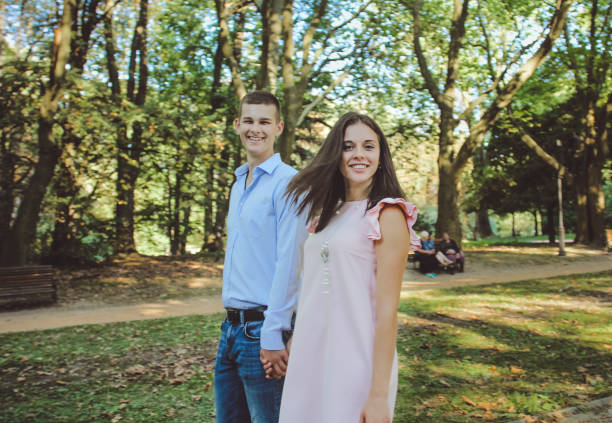 istock Happy couple walking and smiling in the park 684089906
