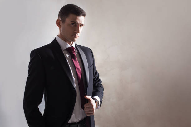 istock Young man in a tuxedo with tie. Is adjusting his jacket 684093368