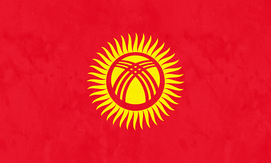 A red field charged with a yellow sun with forty uniformly spaced rays; the sun is crossed by two sets of three lines, the national flag of Kyrgyzstan, adopted on 3 March 1992.
