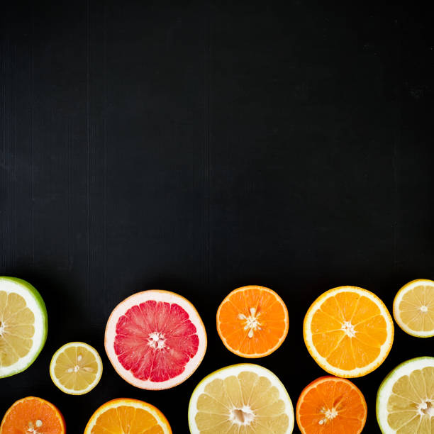 istock Oranges, grapefruit and lemon isolated on black background. Flat lay, top view. Tropical summer mix of fruits 684096894