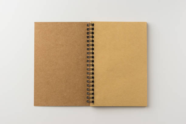 istock Top view of spiral blank notebook on white background 684097206