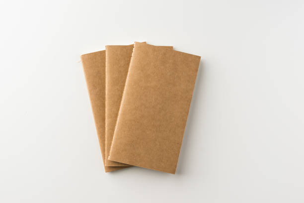 istock Top view of three kraft blank notebook on white background 684097666