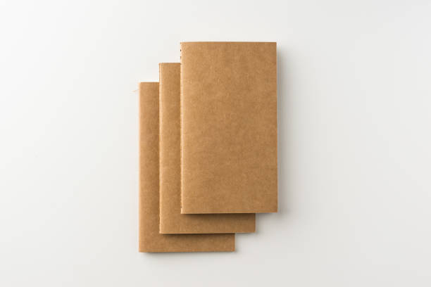 istock Top view of three kraft blank notebook on white background 684097778