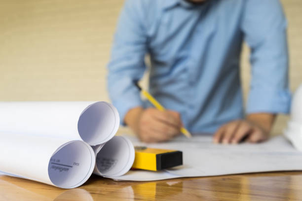 istock business, architect drawing blueprint on wooden table, engineering concept, architecture concept 684115978