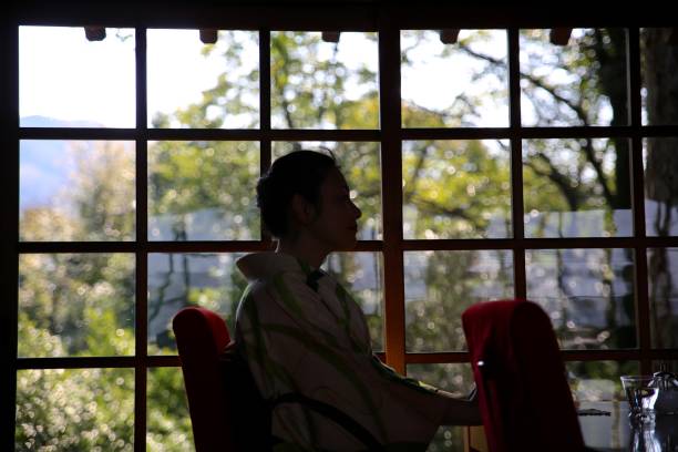 istock Woman reading book in cafe 684117398