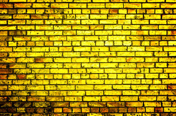 istock Texture of golden brick wall high contrasted with vignetting effect 684118944
