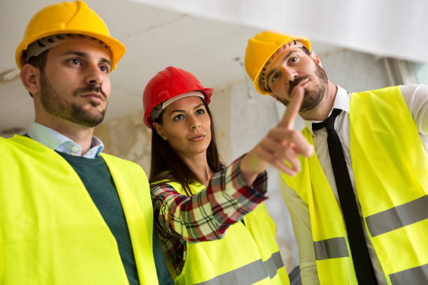 istock Group of architect watching some details on blueprints at construction site 684122002