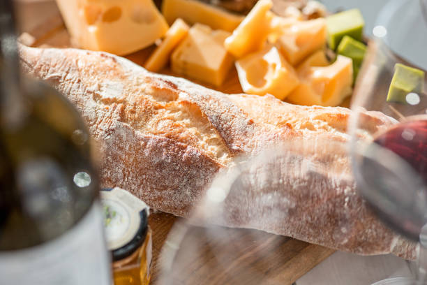 istock Wine, baguette and cheese on wooden background 684122390