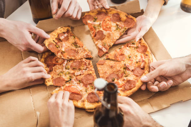 istock human hands holding slices of pizza 684125446