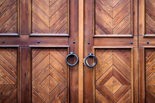 Retro door with beautiful wooden texture and round metal decorative handles.