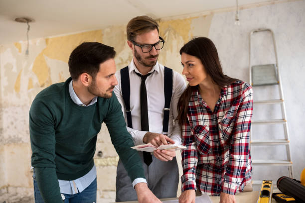 istock Team of architects working on construction plans 684129106