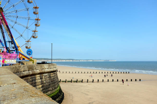 Bridlington, Yorkshire, UK. May 10, 2017. The beach with the funfair in the foreground and Flamborough head in the bachground at the North bay in Bridlington Yorkshire.