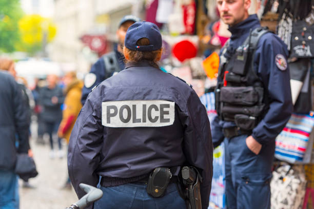 Policemen patrolling at market, Montmartre hill in Paris Policemen patrolling at market, Montmartre hill in Paris officer military rank stock pictures, royalty-free photos & images