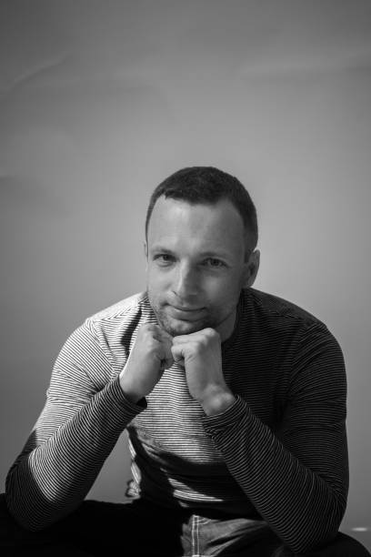 istock Vertical black and white portrait of sitting man 684145396