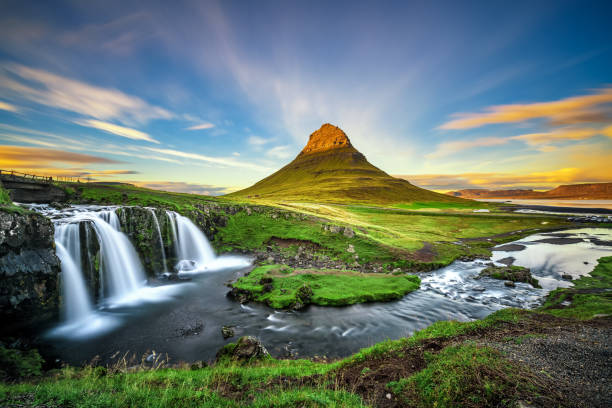 Sunset over Kirkjufellsfoss Waterfall and Kirkjufell mountain in Iceland Summer sunset over the famous Kirkjufellsfoss Waterfall with Kirkjufell mountain in the background in Iceland. Long exposure. kirkjufell stock pictures, royalty-free photos & images