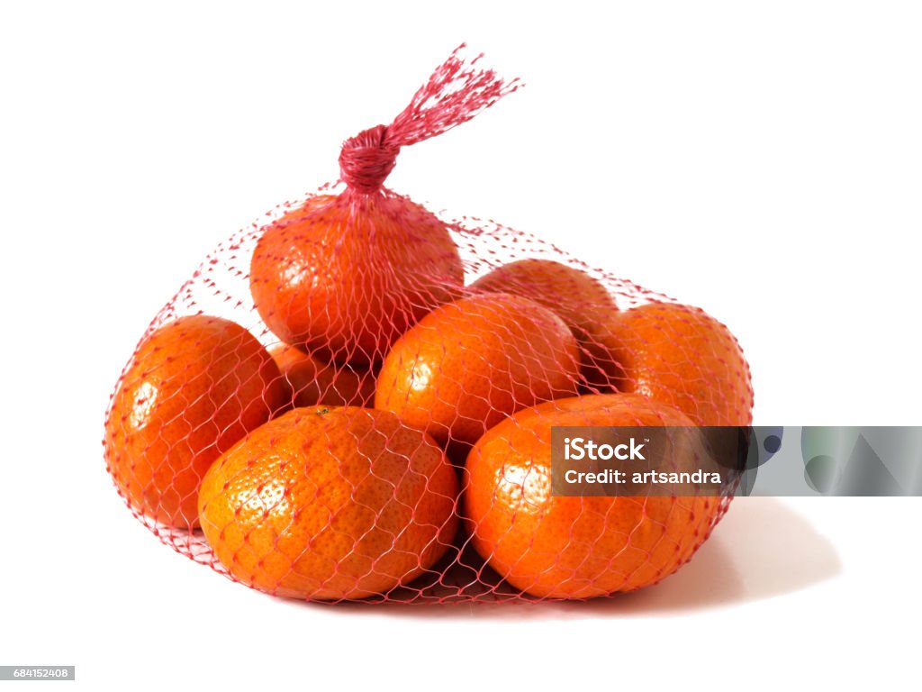 Mandarins in the net bag Mandarins in the net bag on a white background Tangerine Stock Photo