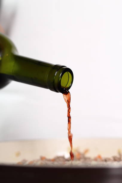 istock Pouring red wine into skillet. Making Lasagna Bolognese Series. 684167420