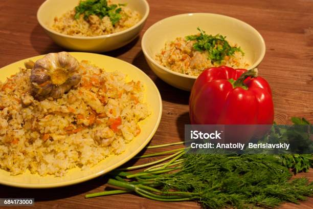 Pilaf On The Clay Plate On A Wooden Table Stock Photo - Download Image Now - Animal, Beef, Biryani