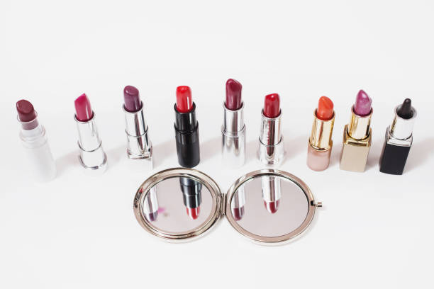 istock Multi-colored lipstick on white background. Reflection of lipstick in the mirror. Composition with makeup and a mirror. View from above. Concept. Decorative cosmetics, flat lay 684185348