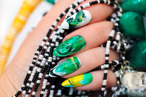 Stone nail design in white and green colors.
